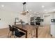 Open dining area with dark wood table, black chairs, and modern light fixture at 252 S Cholla St, Gilbert, AZ 85233