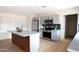 Modern kitchen featuring gray cabinets, an island with a marble countertop, and stainless steel appliances at 252 S Cholla St, Gilbert, AZ 85233