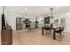 Bright, open kitchen featuring stainless steel appliances, gray cabinetry, and dining table with chairs at 252 S Cholla St, Gilbert, AZ 85233