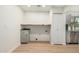 Well-lit laundry area with modern gray cabinets and wood counters at 252 S Cholla St, Gilbert, AZ 85233