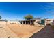 Wide shot of the backyard, showcasing the gravel landscaping, covered patio, and the home's exterior at 2939 E Paradise Ln, Phoenix, AZ 85032