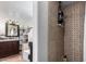 Bathroom featuring a shower with tiled walls, vanity with sink, and open shelving for storage at 2939 E Paradise Ln, Phoenix, AZ 85032