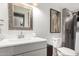 Updated bathroom with a modern sink, silver-framed mirror, and a tiled shower at 2939 E Paradise Ln, Phoenix, AZ 85032