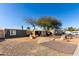 Features mature trees, desert landscaping, and a driveway leading to the front of the home at 2939 E Paradise Ln, Phoenix, AZ 85032