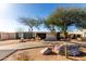 View of front yard with mature trees, desert landscaping, and a walkway to the home's entrance at 2939 E Paradise Ln, Phoenix, AZ 85032