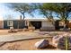 Charming single-story home with desert landscaping and a long driveway leading to the entrance at 2939 E Paradise Ln, Phoenix, AZ 85032