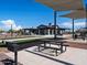 Community picnic tables and grill with shade structures provide an outdoor area for residents to socialize and barbecue at 3550 E Audrey Dr, San Tan Valley, AZ 85143