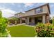 Expansive backyard features artificial grass, desert landscaping, and a covered patio perfect for entertaining at 3551 E Louise Dr, Phoenix, AZ 85050