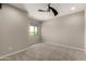 Bright bedroom features plush carpet, a modern ceiling fan, and a large window at 3551 E Louise Dr, Phoenix, AZ 85050