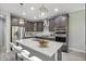 Stylish kitchen boasts modern appliances, quartz countertops, and bar stool seating at a center island at 3551 E Louise Dr, Phoenix, AZ 85050