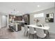 Open kitchen and dining area with dark wood cabinets, stainless steel appliances, and a marble countertop table at 3551 E Louise Dr, Phoenix, AZ 85050