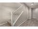 Carpeted staircase featuring white railings and wood-look tile flooring at 3551 E Louise Dr, Phoenix, AZ 85050