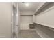 This walk-in closet features custom built-ins and an attached bathroom with a walk-in shower at 3551 E Louise Dr, Phoenix, AZ 85050