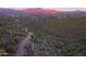 Panoramic aerial view of desert landscape with mountains in the distance, cactus, and winding roads at 39332 N Old Stage Rd, Cave Creek, AZ 85331