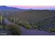 Overhead view of a desert landscape at sunset, featuring lush greenery and rolling hills at 39332 N Old Stage Rd, Cave Creek, AZ 85331