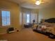 Bright bedroom with a ceiling fan, plush carpet, and a large window with shutters at 42920 N Raleigh Ct, Anthem, AZ 85086