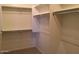 Walk-in closet features built-in shelving and bars for hanging clothes at 42920 N Raleigh Ct, Anthem, AZ 85086