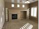 Living room with carpet flooring, fireplace, built in shelving, and light-colored walls at 42920 N Raleigh Ct, Anthem, AZ 85086