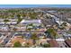 Wide aerial shot of the neighborhood, showing tree-lined streets and nearby commercial areas at 440 W 1St W St, Mesa, AZ 85201