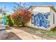 Quaint backyard with a splash of color from flowers with blue and white graffiti at 440 W 1St W St, Mesa, AZ 85201