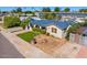 Inviting single-story home boasts a blue roof, green grass, and mature landscaping at 440 W 1St W St, Mesa, AZ 85201