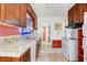 Functional kitchen featuring wood cabinetry, tile countertops, and essential appliances at 440 W 1St W St, Mesa, AZ 85201