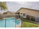 Fenced backyard featuring a sparkling swimming pool and lounge chairs, creating an inviting outdoor retreat for enjoyment at 486 E Devon Dr, Gilbert, AZ 85296