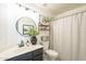 Modern bathroom features a round mirror, vanity with marble countertop, and neutral accents for a stylish and relaxing space at 486 E Devon Dr, Gilbert, AZ 85296