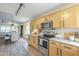 Well-lit kitchen with stainless steel appliances and warm wood cabinetry at 486 E Devon Dr, Gilbert, AZ 85296