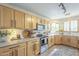 Bright kitchen with light wood cabinets, stainless steel appliances, and natural light at 486 E Devon Dr, Gilbert, AZ 85296