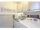 Functional laundry room with modern washer and dryer, custom cabinets, and stylish decor at 486 E Devon Dr, Gilbert, AZ 85296