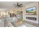 Stylish living room featuring a comfortable sofa, modern fireplace, and open layout to dining area at 486 E Devon Dr, Gilbert, AZ 85296