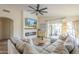 Bright living room showcasing a comfortable sectional sofa, modern fireplace, and large TV at 486 E Devon Dr, Gilbert, AZ 85296