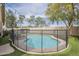 A private fenced in backyard pool is surrounded by artificial turf and shade trees, creating a serene outdoor oasis at 486 E Devon Dr, Gilbert, AZ 85296