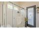 Bright bathroom featuring a glass shower with a bench and a dark-framed glass door at 486 E Devon Dr, Gilbert, AZ 85296