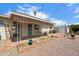 Inviting back patio with desert landscaping, offering a cozy outdoor space to relax and enjoy the serene surroundings at 5463 E Albany St, Mesa, AZ 85205