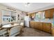 Bright kitchen with linoleum floors, vintage decor, and a cozy dining area for casual meals at 5463 E Albany St, Mesa, AZ 85205