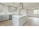 Spacious kitchen featuring a large island, modern range hood, and open design, ideal for Gathering gatherings and entertaining at 562 N 104Th St, Mesa, AZ 85207