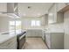 Bright kitchen with gray cabinets, modern appliances, and a sleek island, perfect for cooking and entertaining at 562 N 104Th St, Mesa, AZ 85207