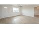 Bright living room with neutral walls, modern ceiling fan, and lots of natural light at 562 N 104Th St, Mesa, AZ 85207