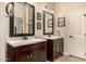 Bathroom featuring two dark wood vanities topped with white sinks and framed mirrors at 6202 E Mckellips Rd # 46, Mesa, AZ 85215