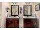 Bathroom featuring two dark wood vanities topped with white sinks and framed mirrors at 6202 E Mckellips Rd # 46, Mesa, AZ 85215