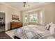 Bright bedroom features a tray ceiling, bay window with shutters, and a flat screen television at 6202 E Mckellips Rd # 46, Mesa, AZ 85215