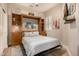 Cozy bedroom featuring a pull-down Murphy bed, built-in shelves, and a wall-mounted television at 6202 E Mckellips Rd # 46, Mesa, AZ 85215