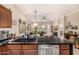 Modern kitchen island with granite countertops and seating, open to living area at 6202 E Mckellips Rd # 46, Mesa, AZ 85215