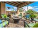 Covered patio with outdoor kitchen, fire pit and comfortable seating area at 6202 E Mckellips Rd # 46, Mesa, AZ 85215