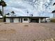 Modern backyard with desert landscaping, an open dining and lounging area, and palm trees at 6429 E Jean Dr, Scottsdale, AZ 85254