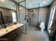 Modern bathroom featuring a sleek double vanity, tile flooring, and glass enclosed shower at 6429 E Jean Dr, Scottsdale, AZ 85254