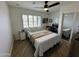 Bright bedroom featuring a ceiling fan, light colored wood floors and closet with mirrored doors at 6429 E Jean Dr, Scottsdale, AZ 85254