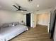 Bedroom featuring a modern ceiling fan, tile floors, and a closet with a sliding barn door at 6429 E Jean Dr, Scottsdale, AZ 85254